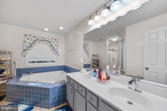 bathroom featuring a garden tub, a sink, a shower stall, and double vanity