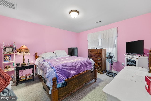 carpeted bedroom featuring visible vents