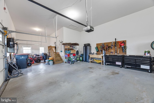 garage featuring a workshop area and a garage door opener