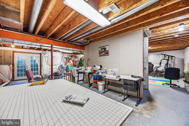 basement with visible vents and french doors