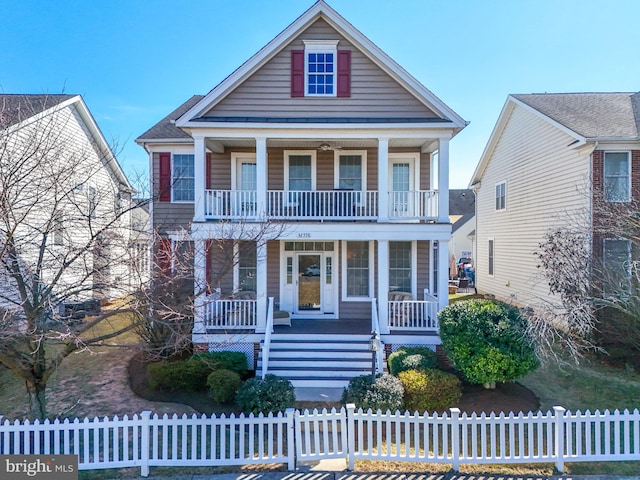 neoclassical home with a fenced front yard and a porch