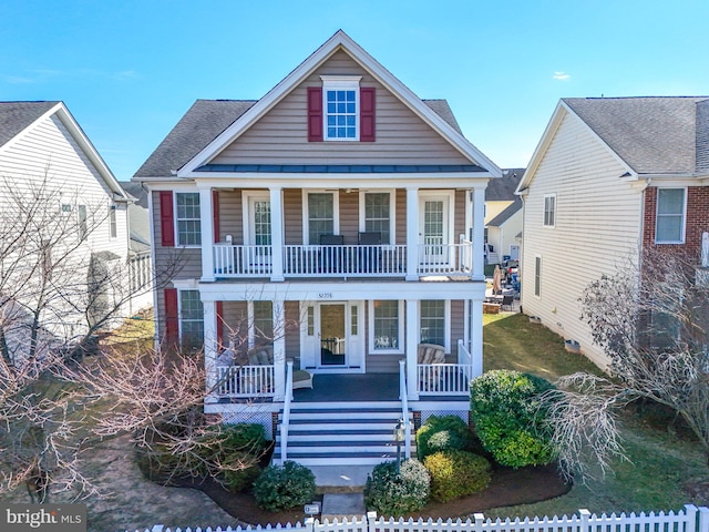 view of front of house with a porch, fence, and roof with shingles