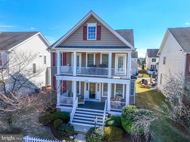 view of front of house featuring stairs, a porch, and a front lawn