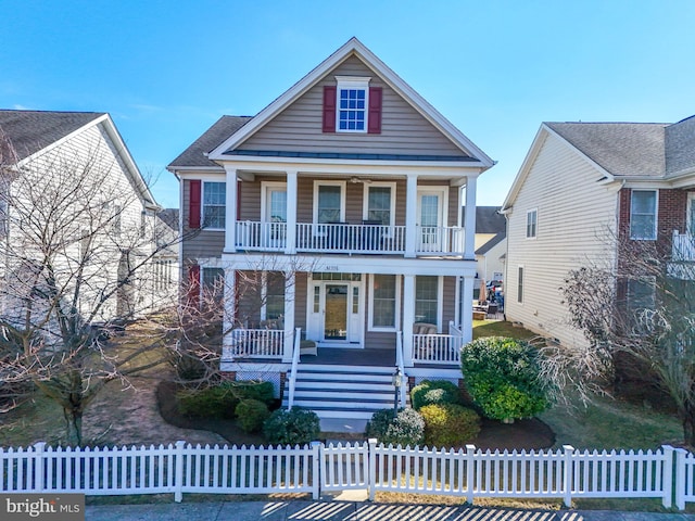 neoclassical / greek revival house with a fenced front yard, covered porch, and a balcony