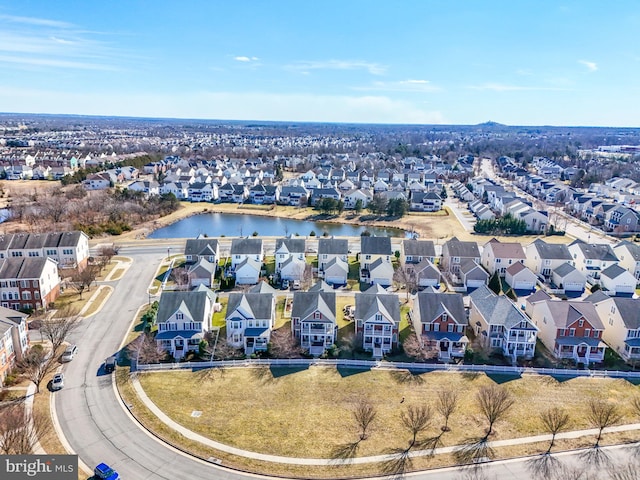 drone / aerial view with a residential view and a water view