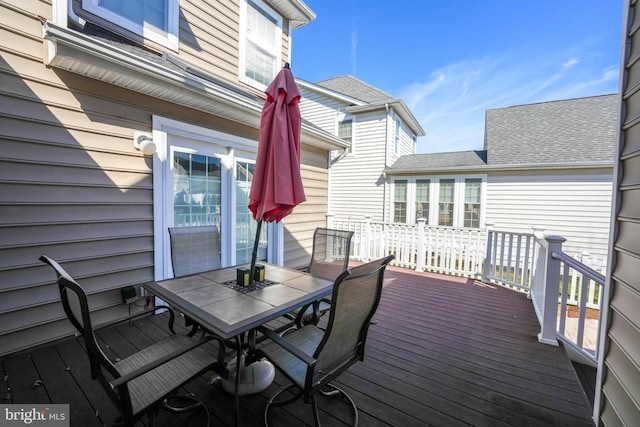 wooden deck featuring outdoor dining area