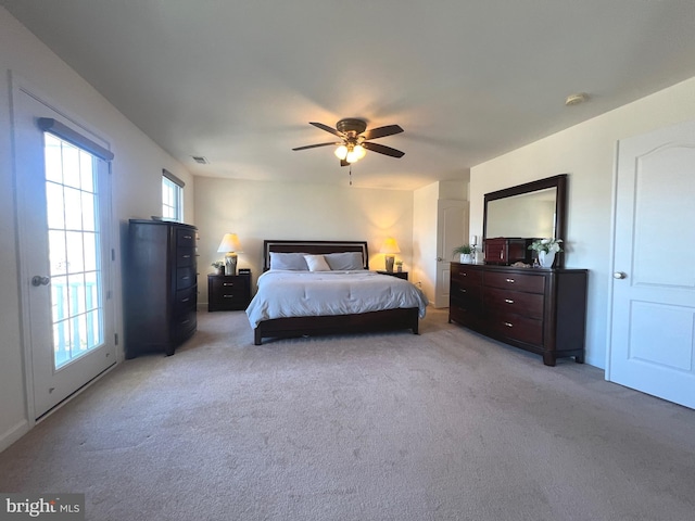 bedroom featuring visible vents, light colored carpet, and ceiling fan