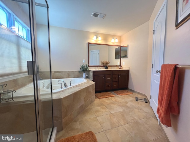 bathroom featuring visible vents, a stall shower, a sink, double vanity, and a bath