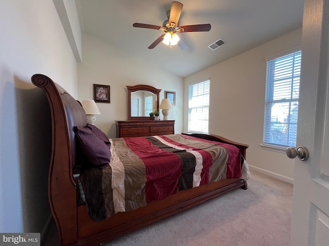 bedroom with a ceiling fan, carpet, visible vents, baseboards, and lofted ceiling