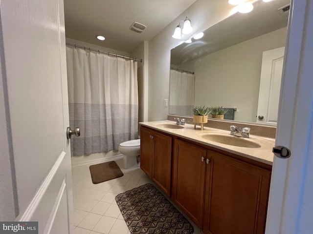 bathroom with tile patterned flooring, double vanity, visible vents, and a sink