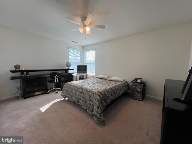 bedroom with visible vents, light colored carpet, and baseboards