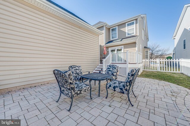 view of patio / terrace featuring a deck and fence