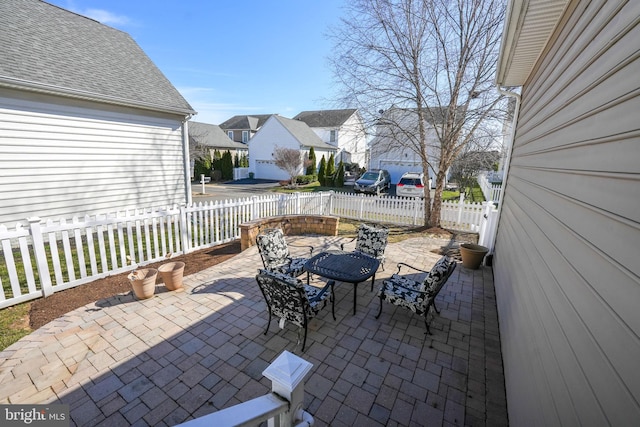 view of patio / terrace with a fenced backyard and a residential view