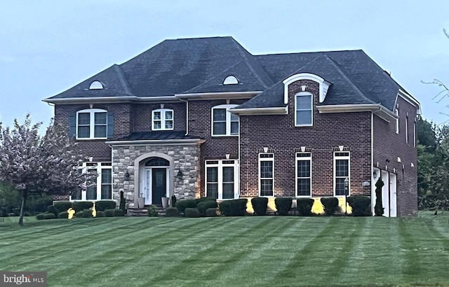 view of front of home with brick siding and a front lawn