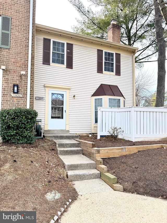 view of front of home featuring a chimney