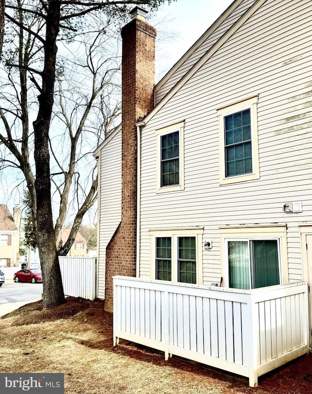 rear view of house featuring a chimney