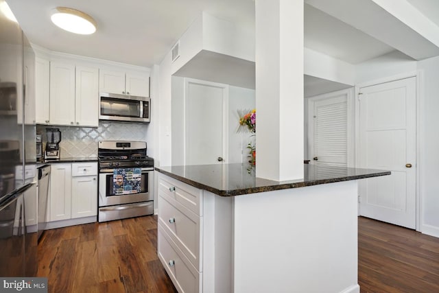 kitchen featuring visible vents, appliances with stainless steel finishes, dark wood finished floors, and white cabinets