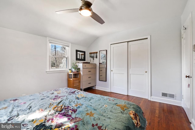 bedroom featuring visible vents, hardwood / wood-style flooring, a closet, lofted ceiling, and ceiling fan