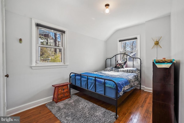 bedroom featuring vaulted ceiling, baseboards, and wood-type flooring