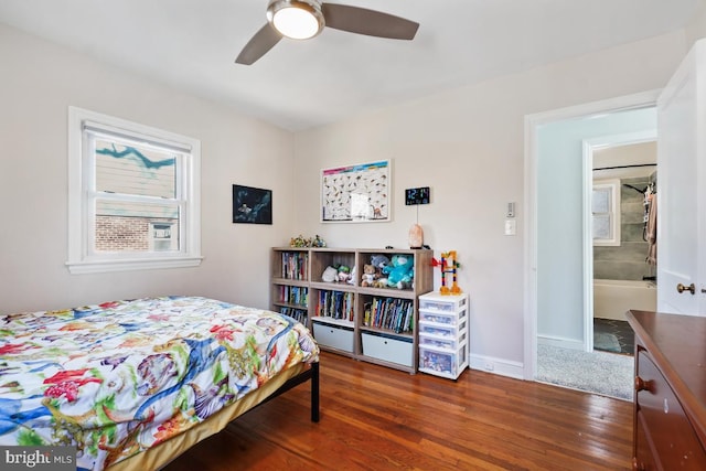 bedroom featuring a ceiling fan, baseboards, and wood finished floors