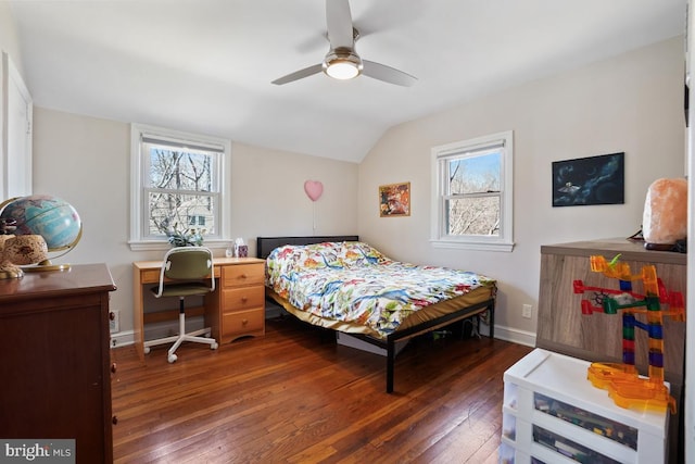 bedroom with baseboards, lofted ceiling, hardwood / wood-style floors, and a ceiling fan