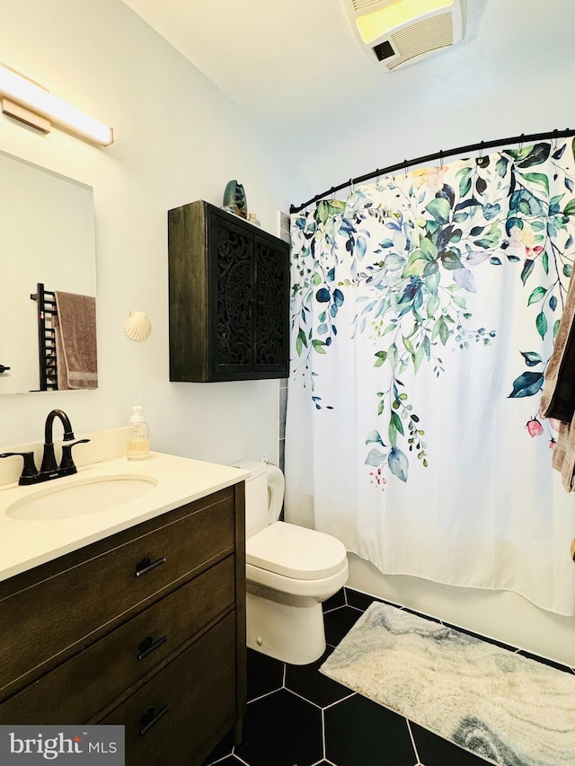 bathroom featuring toilet, shower / bath combination with curtain, vanity, and tile patterned flooring