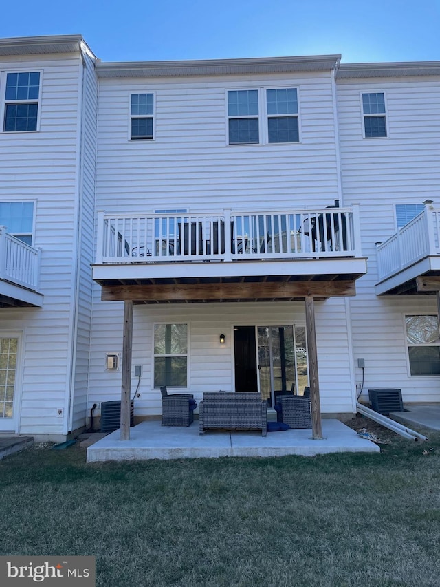 rear view of house featuring a patio area, central AC, an outdoor hangout area, and a lawn