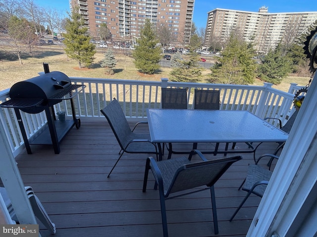 wooden terrace with grilling area and outdoor dining area