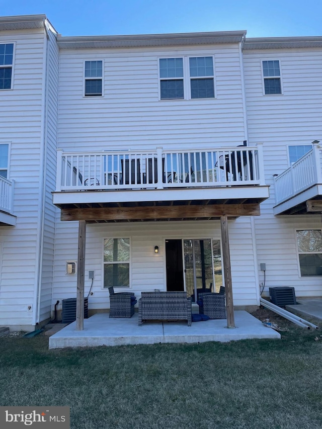 back of house featuring a patio area, a yard, and an outdoor hangout area