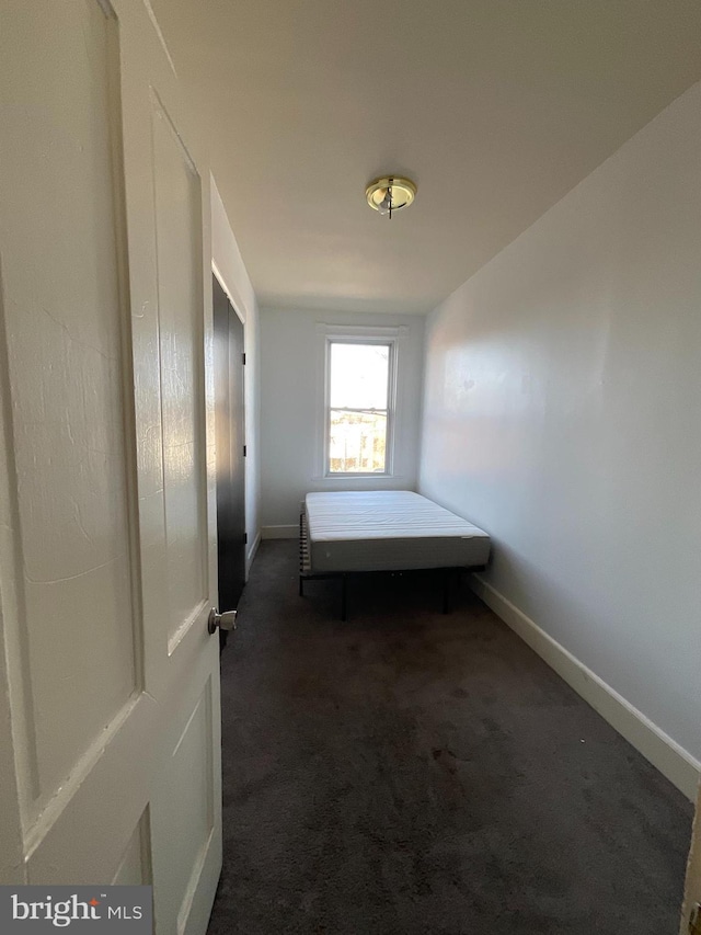 corridor with carpet and baseboards