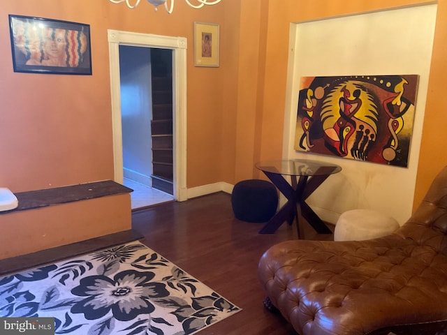 living area featuring baseboards and wood finished floors