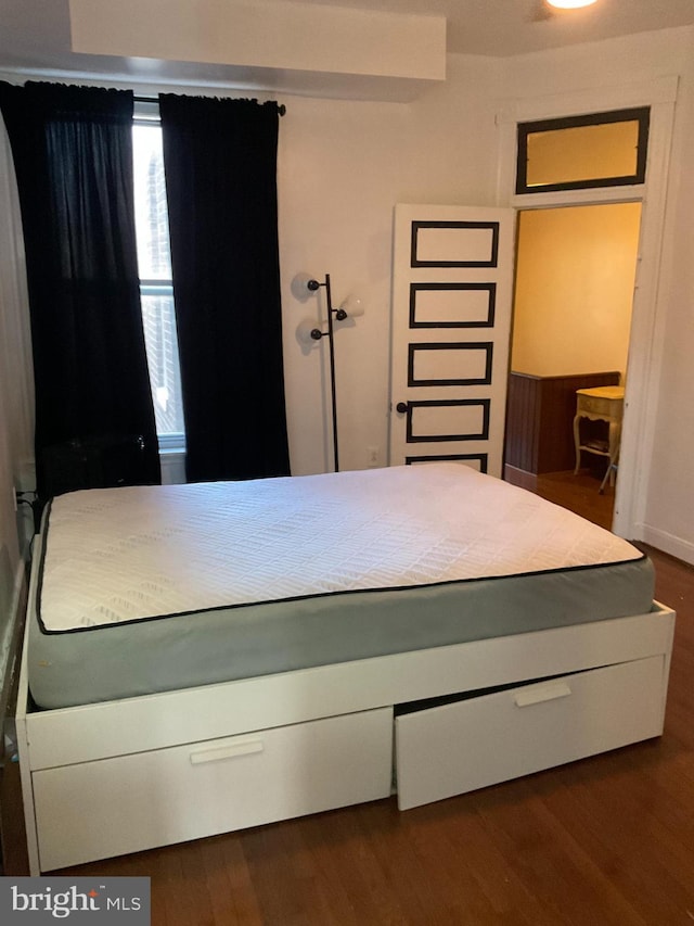 unfurnished bedroom featuring dark wood-type flooring