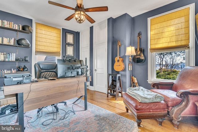 office area with ceiling fan and wood finished floors