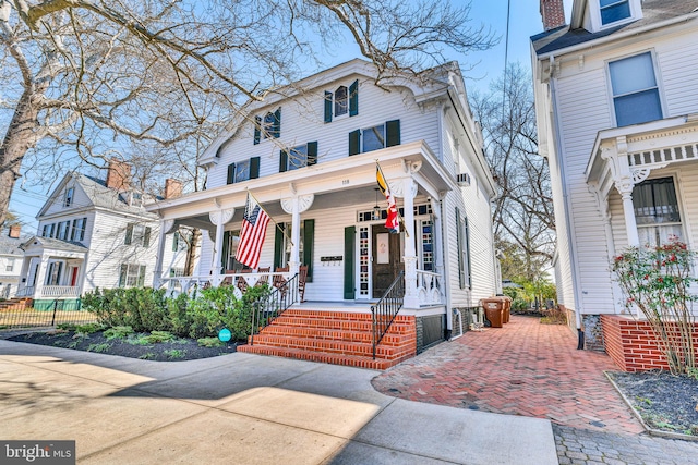 american foursquare style home featuring a porch