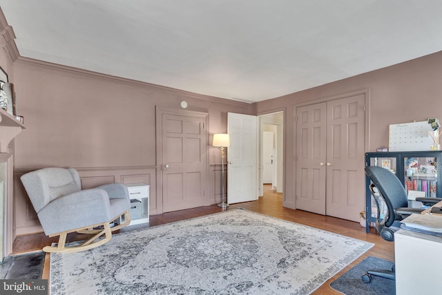 office space with crown molding and wood finished floors