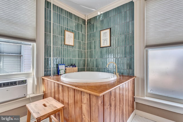 bathroom with a wall mounted air conditioner, a garden tub, and tile walls