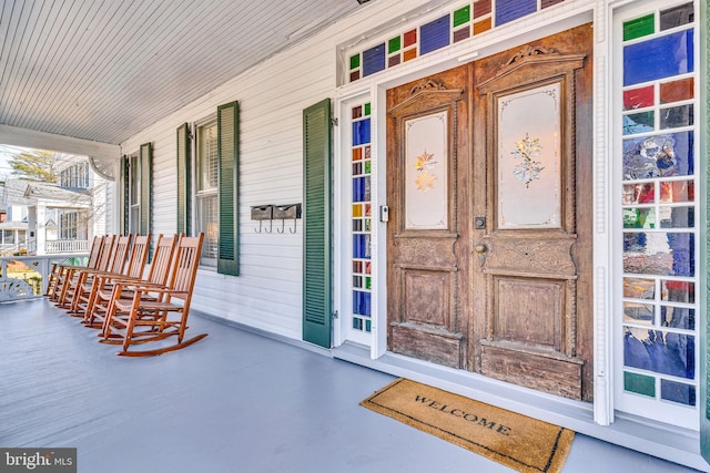 view of exterior entry featuring a porch