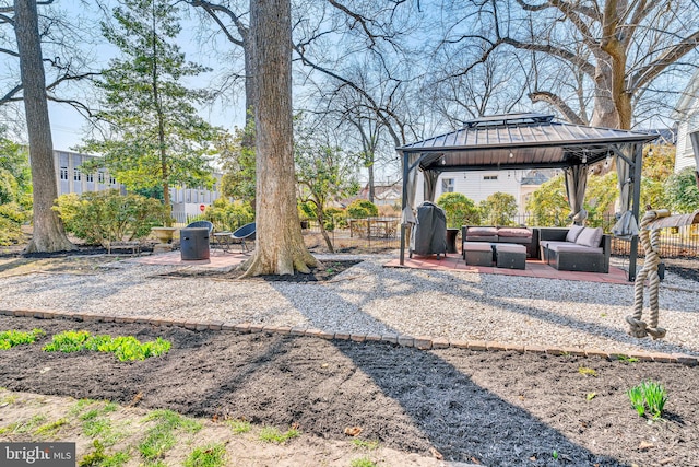 view of yard with fence, an outdoor living space, a patio, and a gazebo