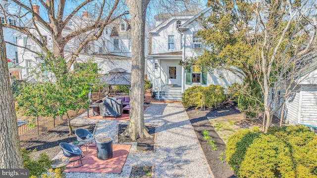 view of front facade featuring a patio and fence