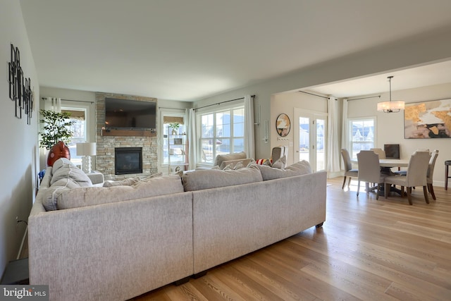 living room featuring a healthy amount of sunlight, light wood-style floors, and a fireplace