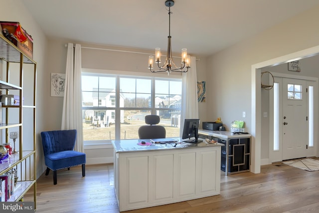 office with baseboards, light wood-style flooring, and a notable chandelier