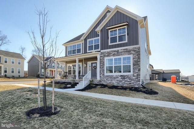 view of front of home featuring stone siding and board and batten siding