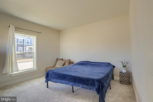 carpeted bedroom featuring baseboards