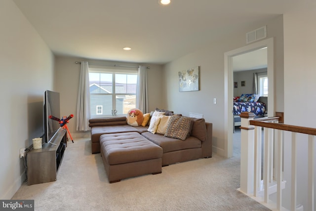 living room featuring light carpet, baseboards, visible vents, and recessed lighting