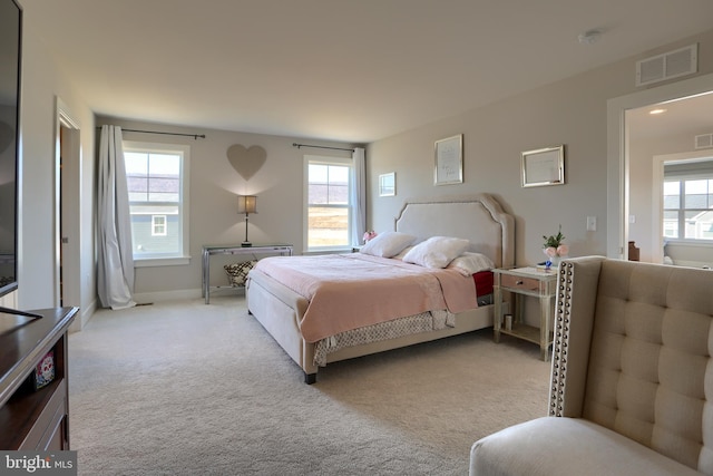 carpeted bedroom featuring visible vents