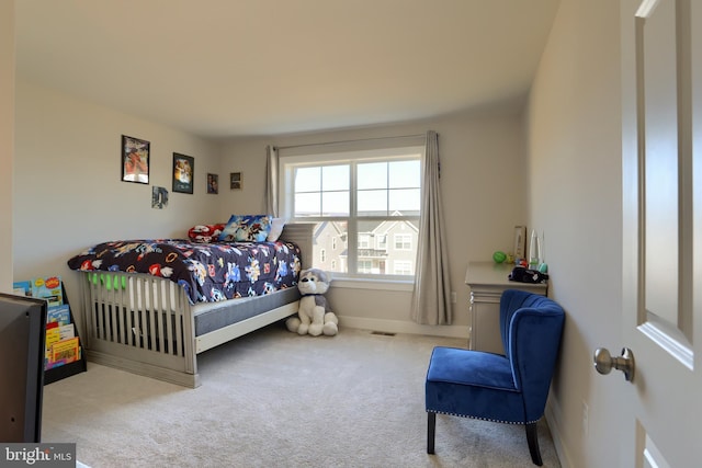 carpeted bedroom featuring baseboards