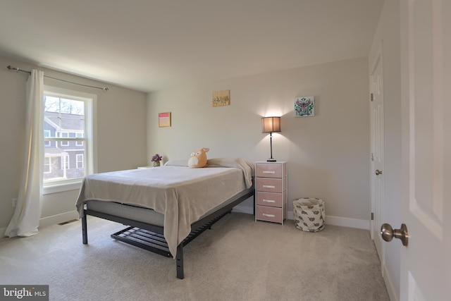 bedroom featuring baseboards and light colored carpet