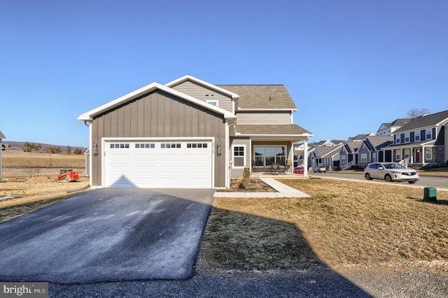 view of front of house featuring a shingled roof, a residential view, aphalt driveway, an attached garage, and board and batten siding