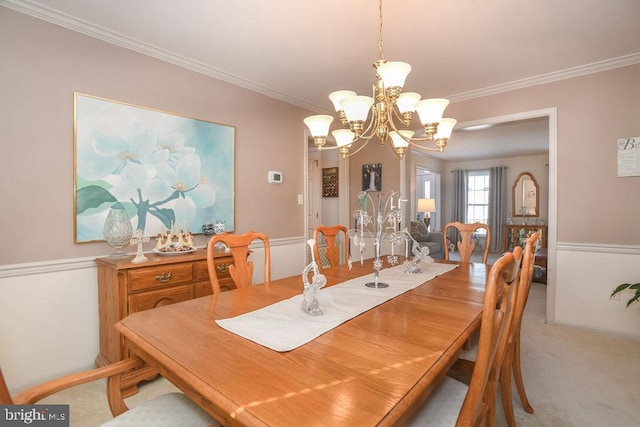 dining space with crown molding, a chandelier, and light carpet