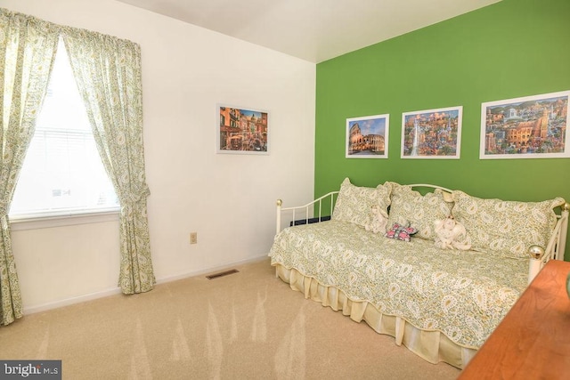 carpeted bedroom featuring baseboards and visible vents